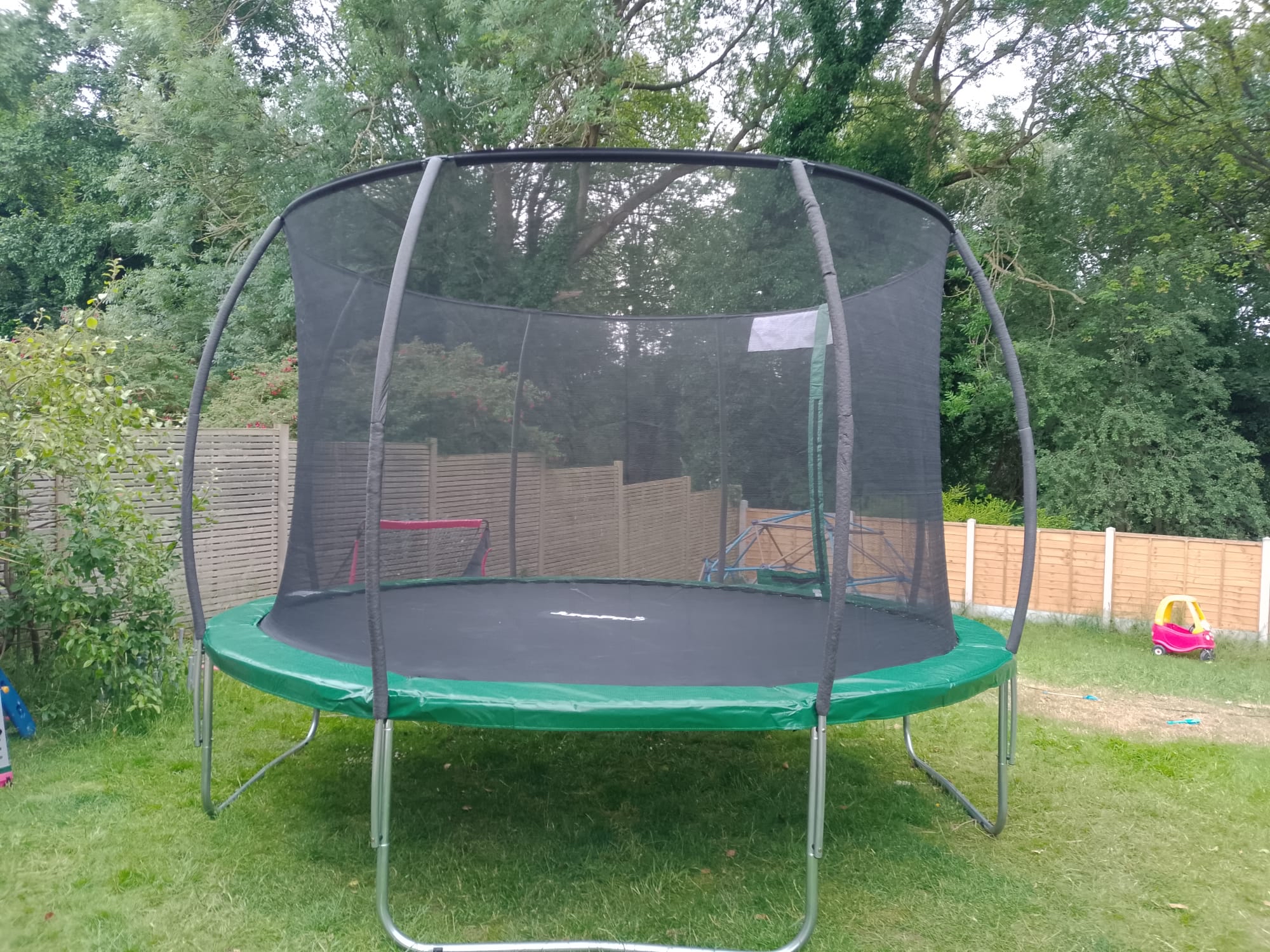 Completed trampoline installation in a garden